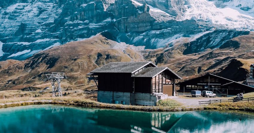 Switzerland - Brown Wooden House and Mountain Reflecting on Lake