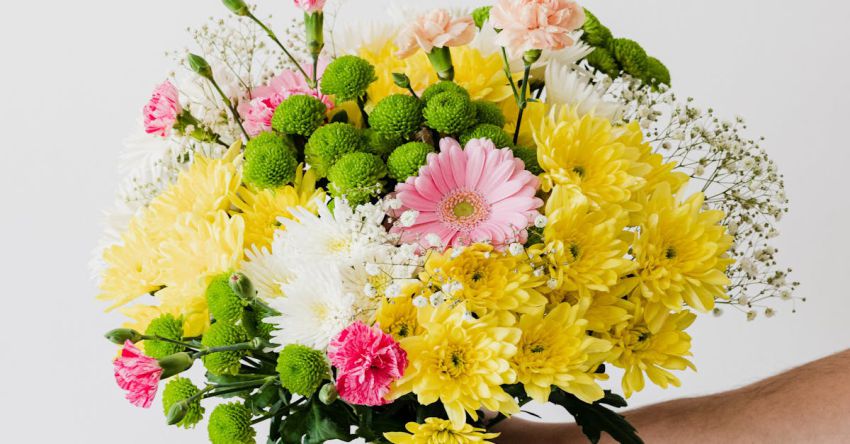 Composers - Crop man with big bouquet in hand