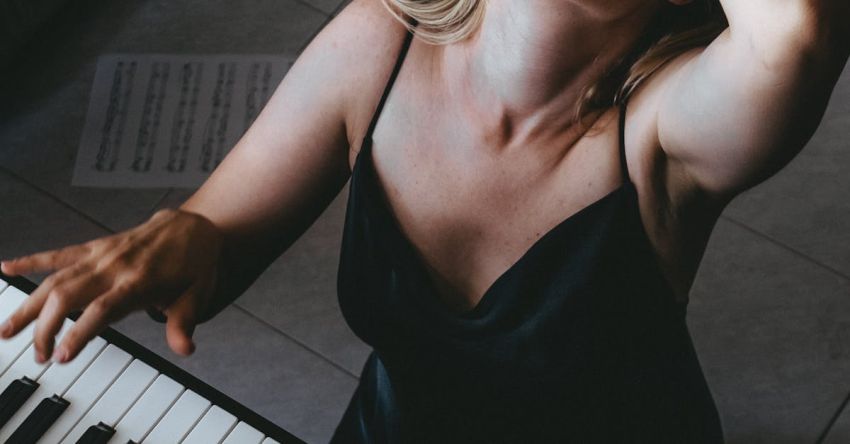 Baroque Music - A woman playing the piano in front of a window