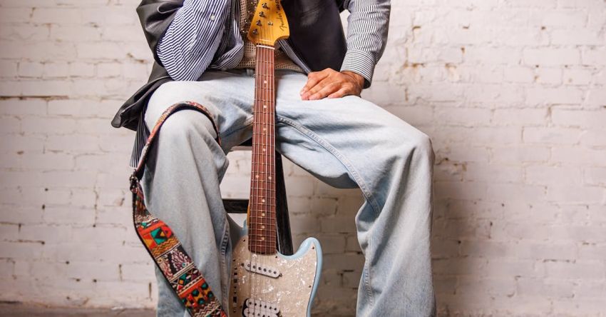 Music Genres - A Fashionable Man Sitting with an Electric Guitar